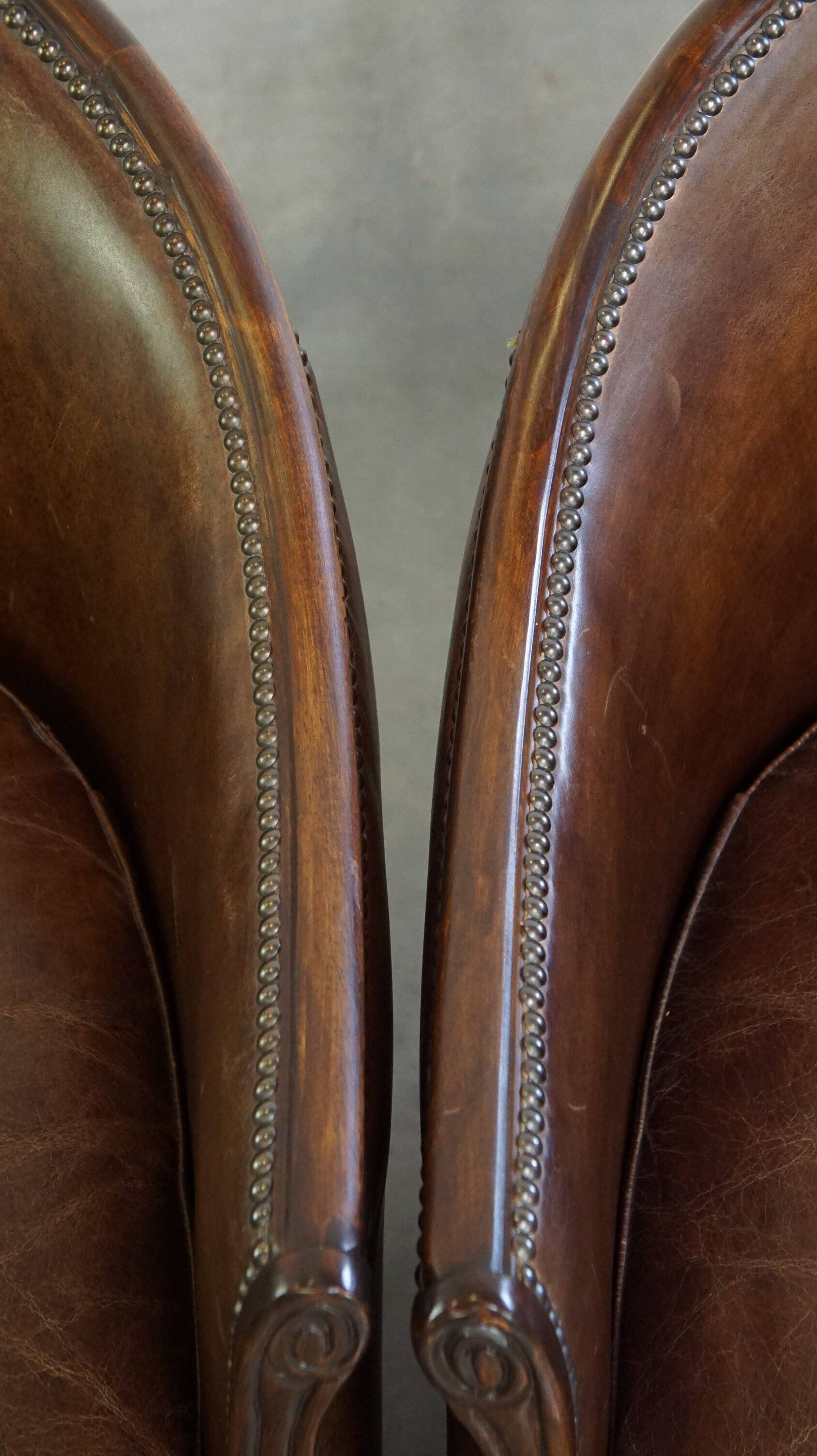 Set of 2 club chairs/armchairs in dark cognac leather