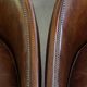 Set of 2 club chairs/armchairs in dark cognac leather