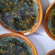 Set of 4 flamed enamel plates in green and amber from the 60s-70s.