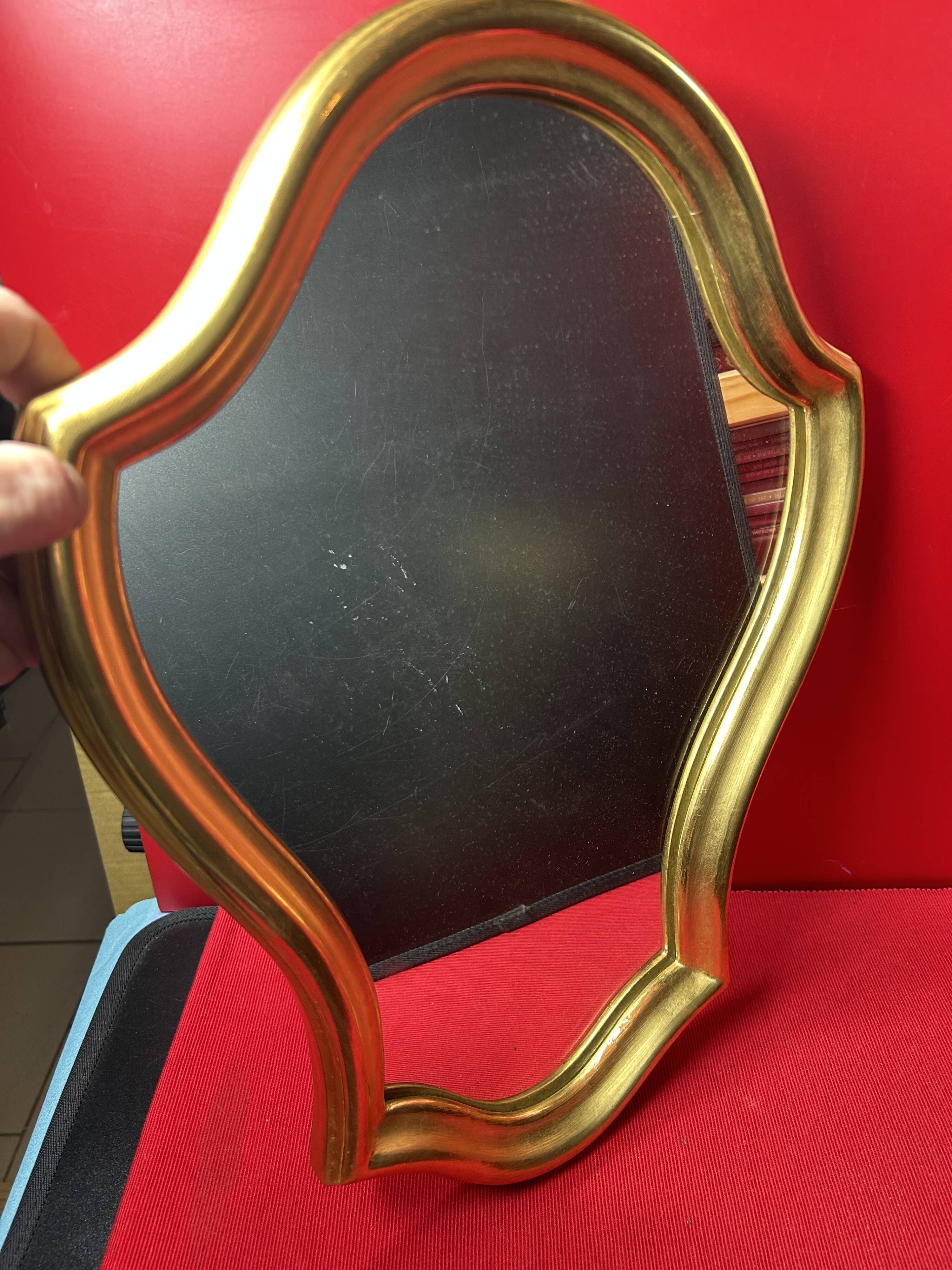 Mirror with a wavy shape, wood and gilded stucco