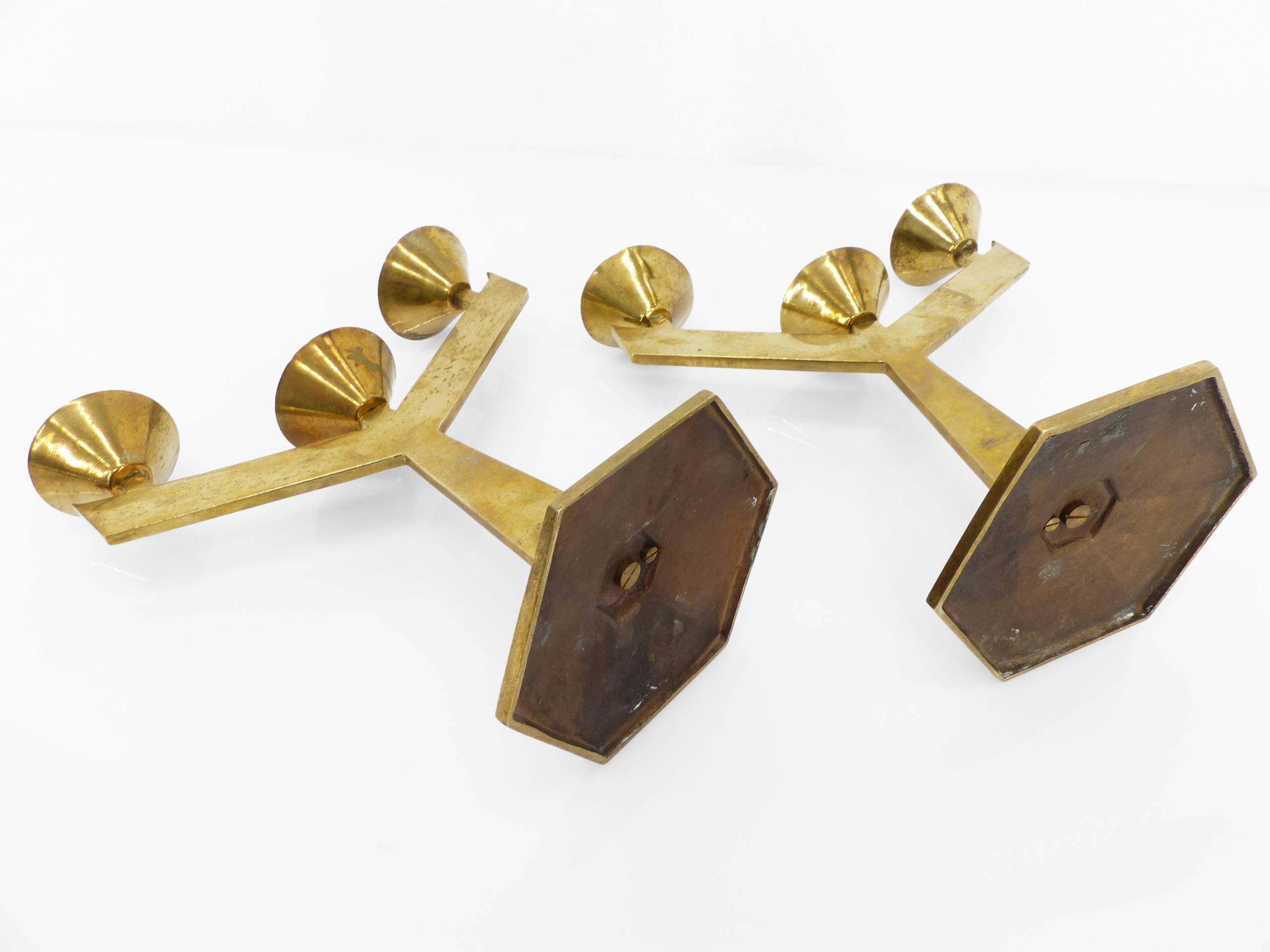 Pair of modernist three-armed solid brass candlesticks, circa 1960