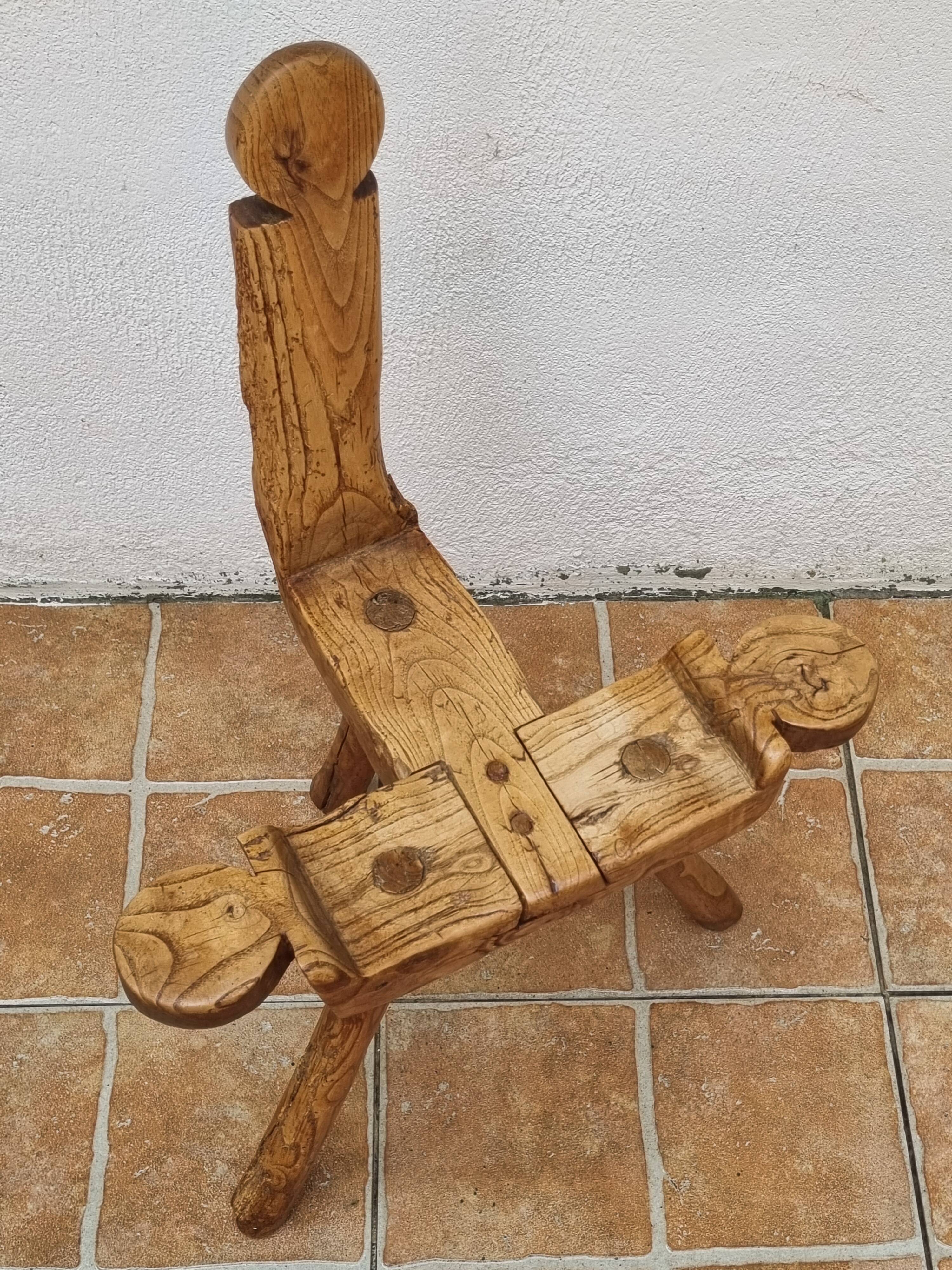 Brutalist chair in solid wood, European handcrafted work from the early 20th century.