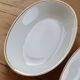 Vintage white porcelain trays with a golden rim.