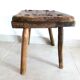 Old milking stool, old farm stool, primitive art.