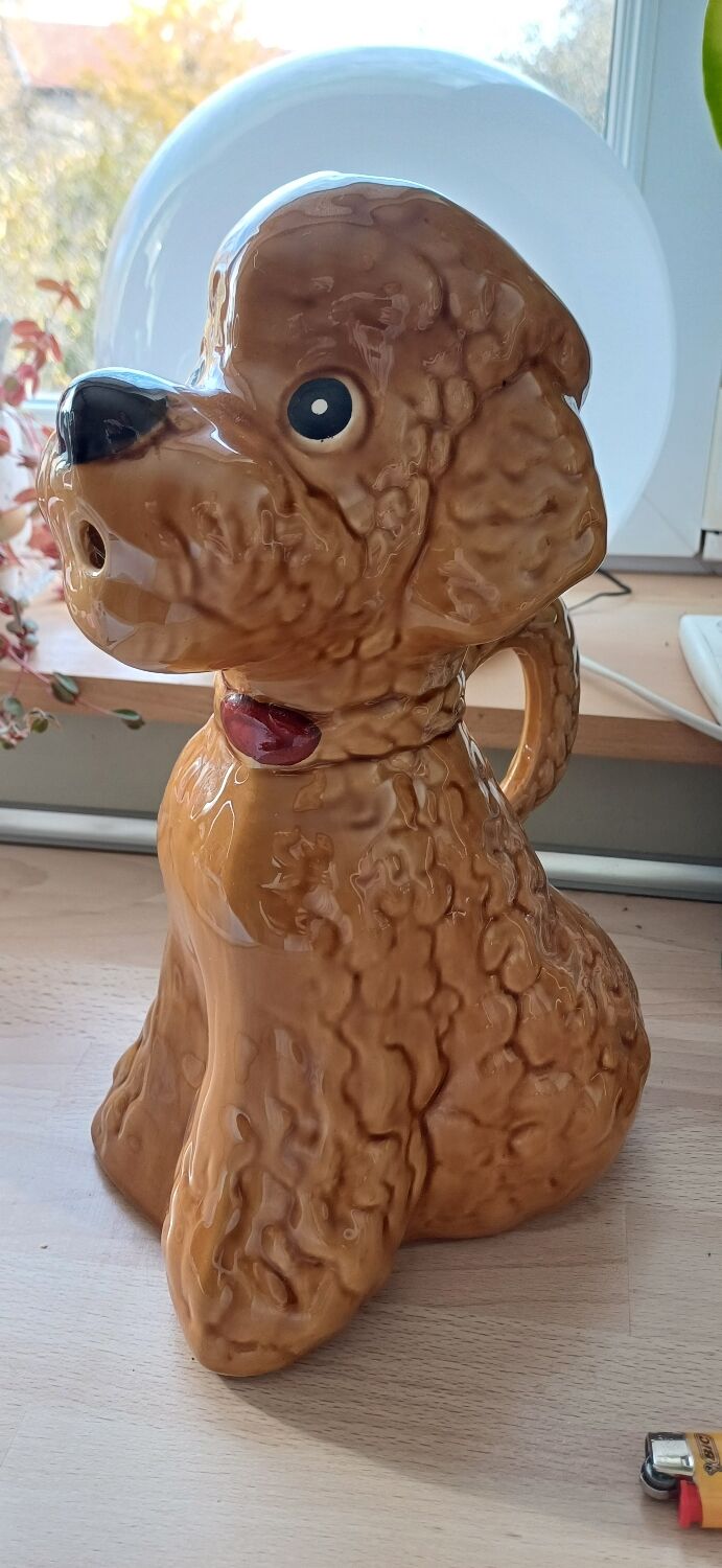 Ancient ceramic pitcher in the shape of a poodle.