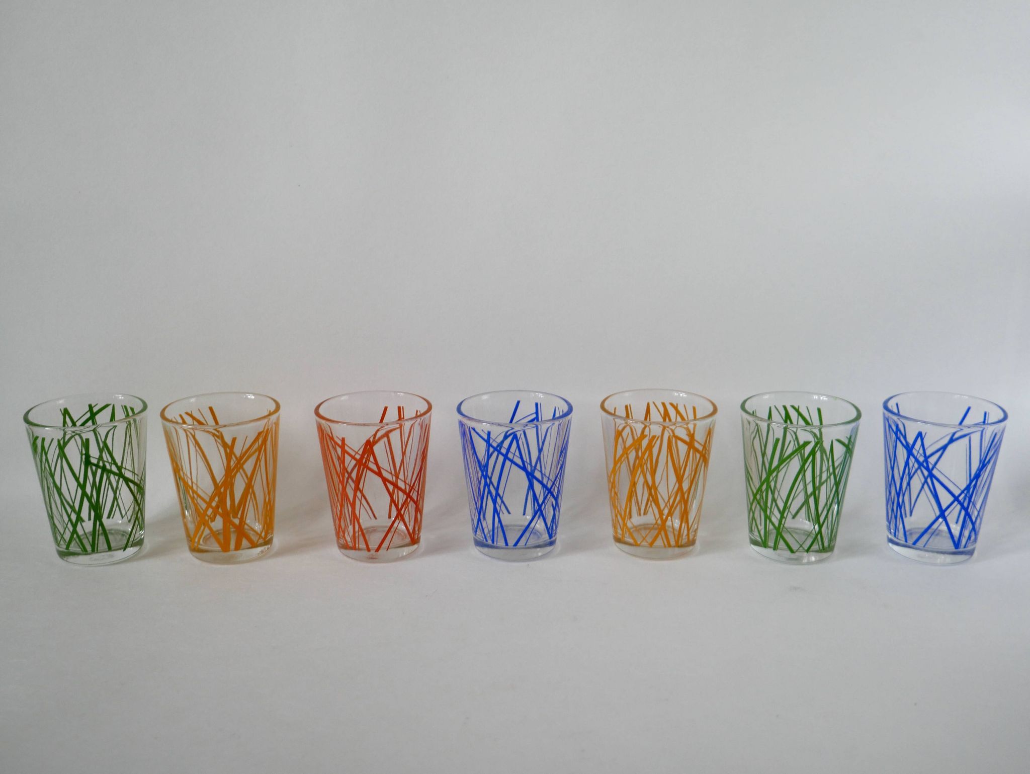 Colorful designer set composed of 7 liqueur glasses and a seventies 70s carafe