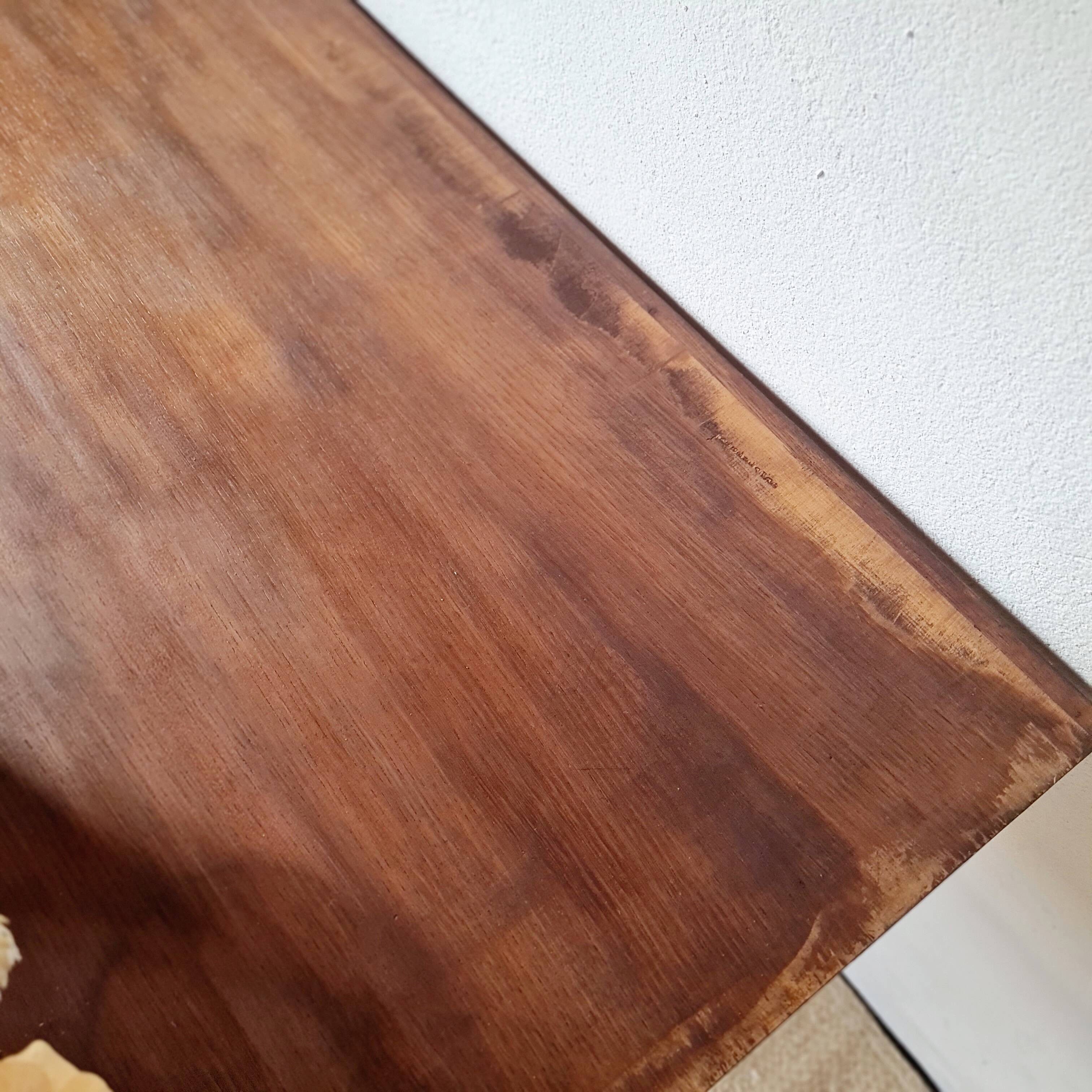 Table with tubular metal legs and wooden top.