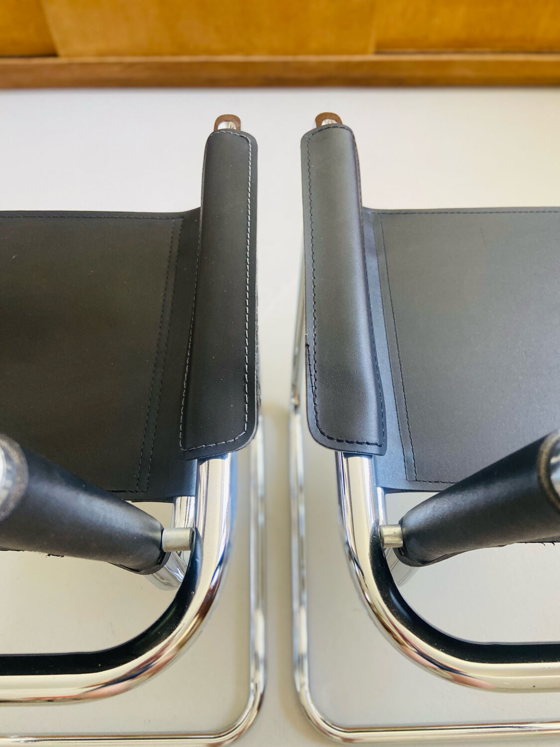 Pair of vintage chrome and black faux leather armchairs