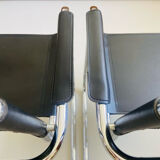 Pair of vintage chrome and black faux leather armchairs