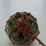 Globe, green glass float and vintage rope