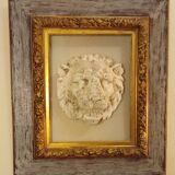 Antique gilded frame with stone lion head ornament on plexiglass