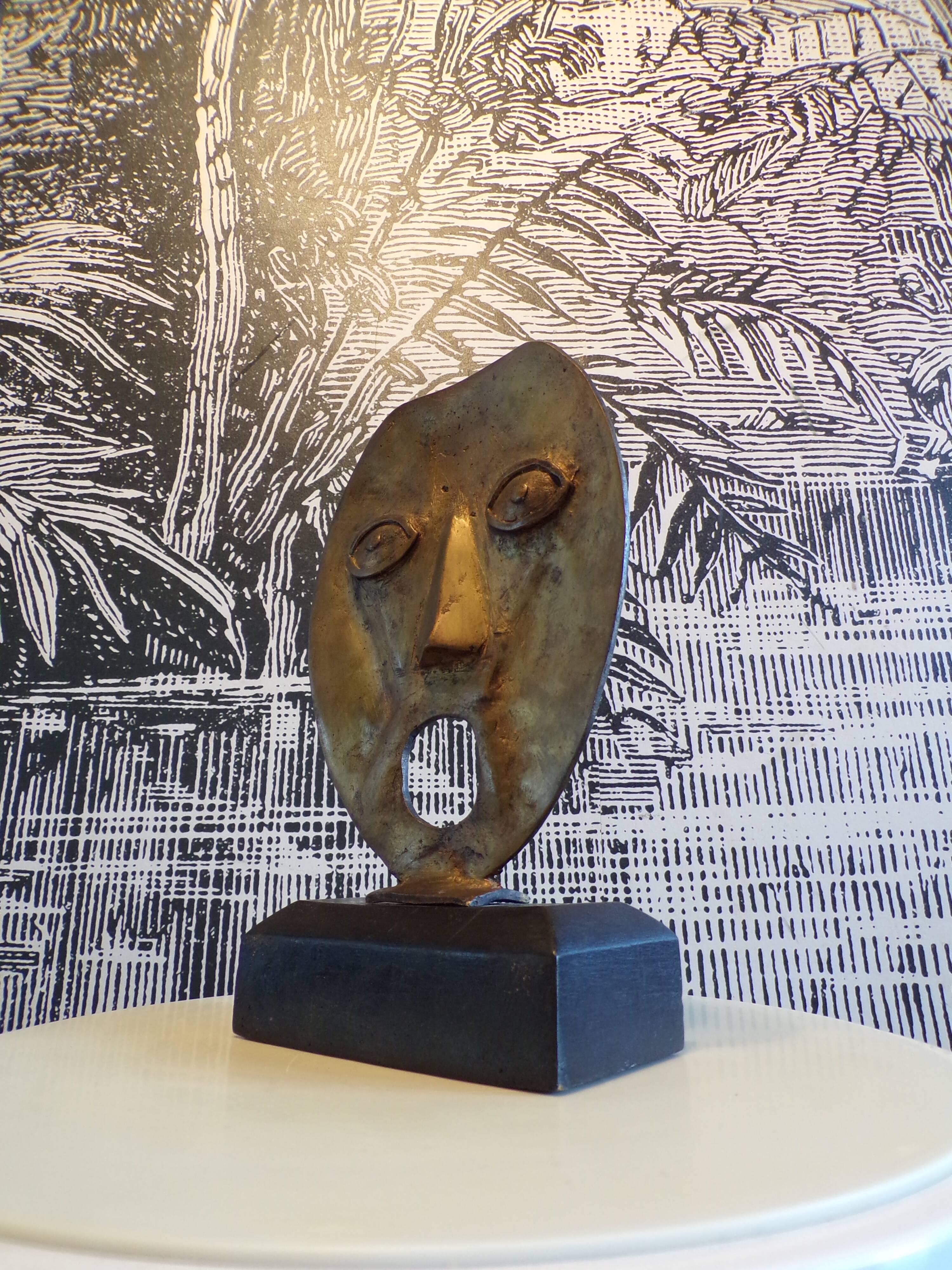 brutalist bronze face sculpture
