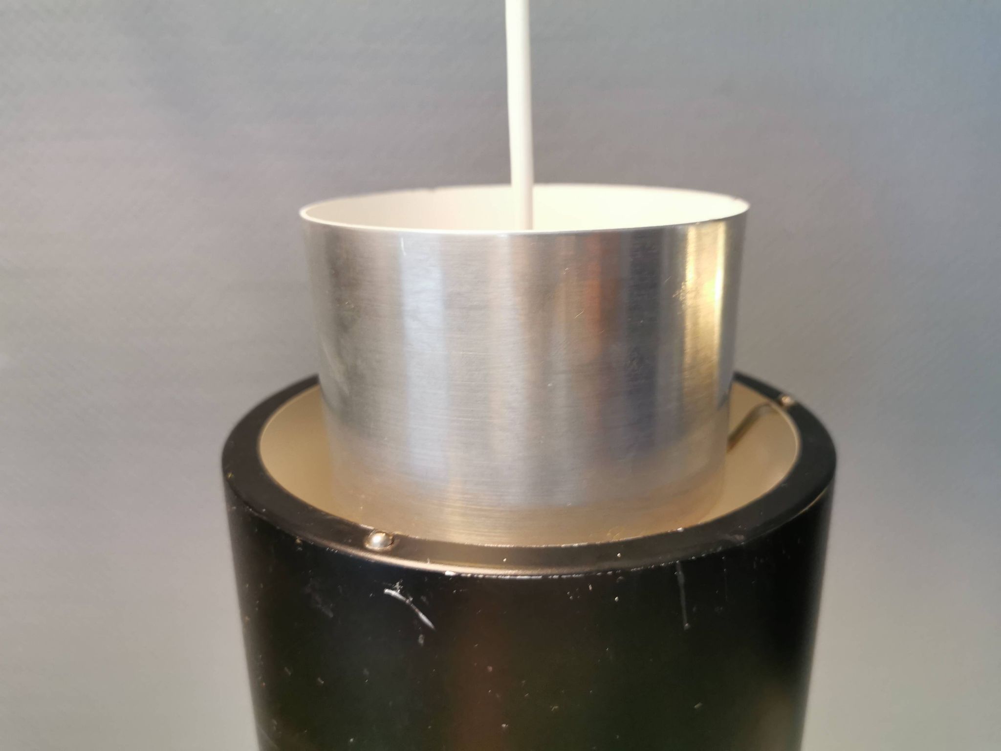 A set of beautiful cylinder shaped hanging lamps in silver color with black "ring" Danish 1970s.