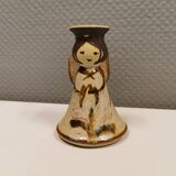 Ceramic candle holder, in the shape of an angel, signed at the bottom.