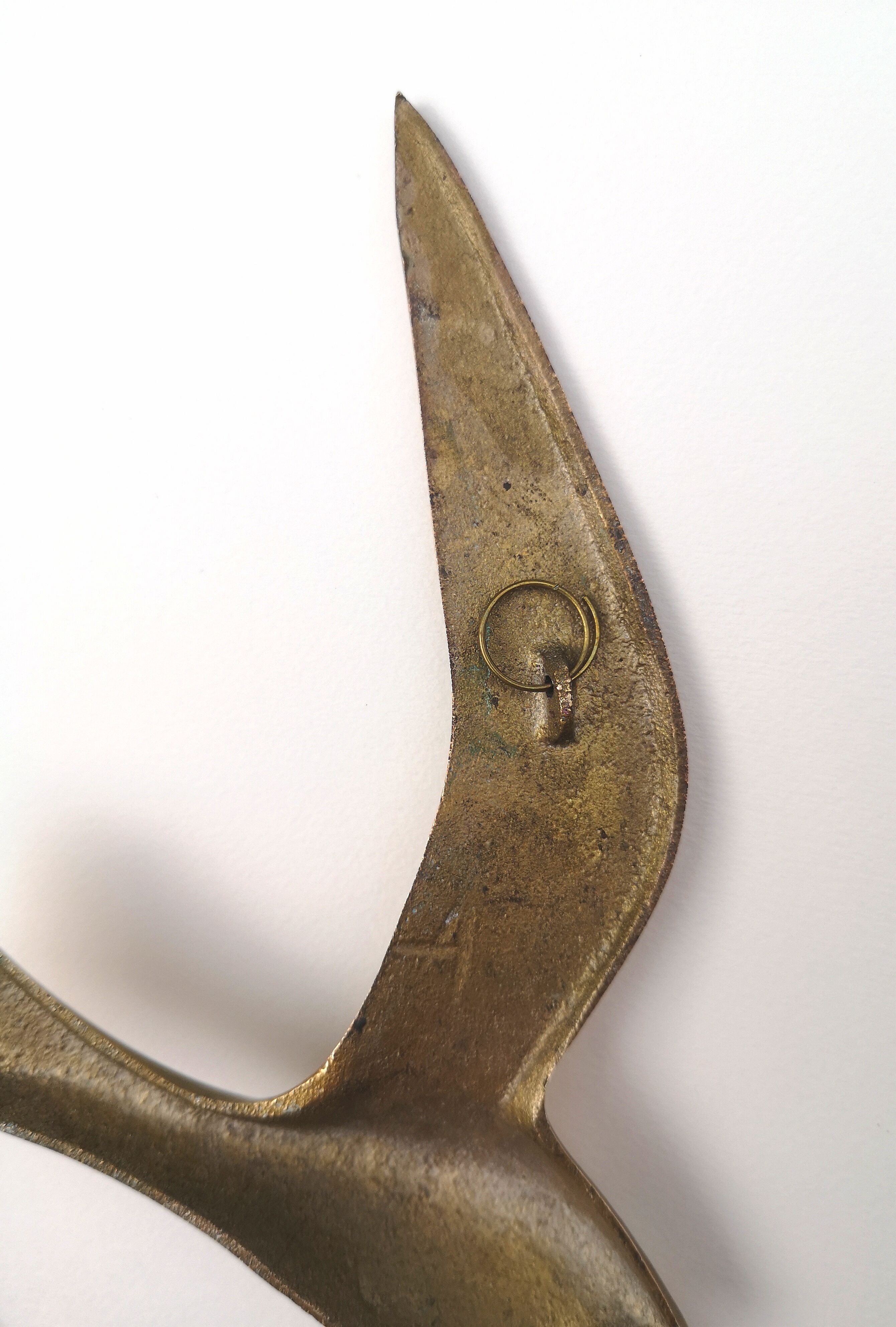 Birds stylized in brass