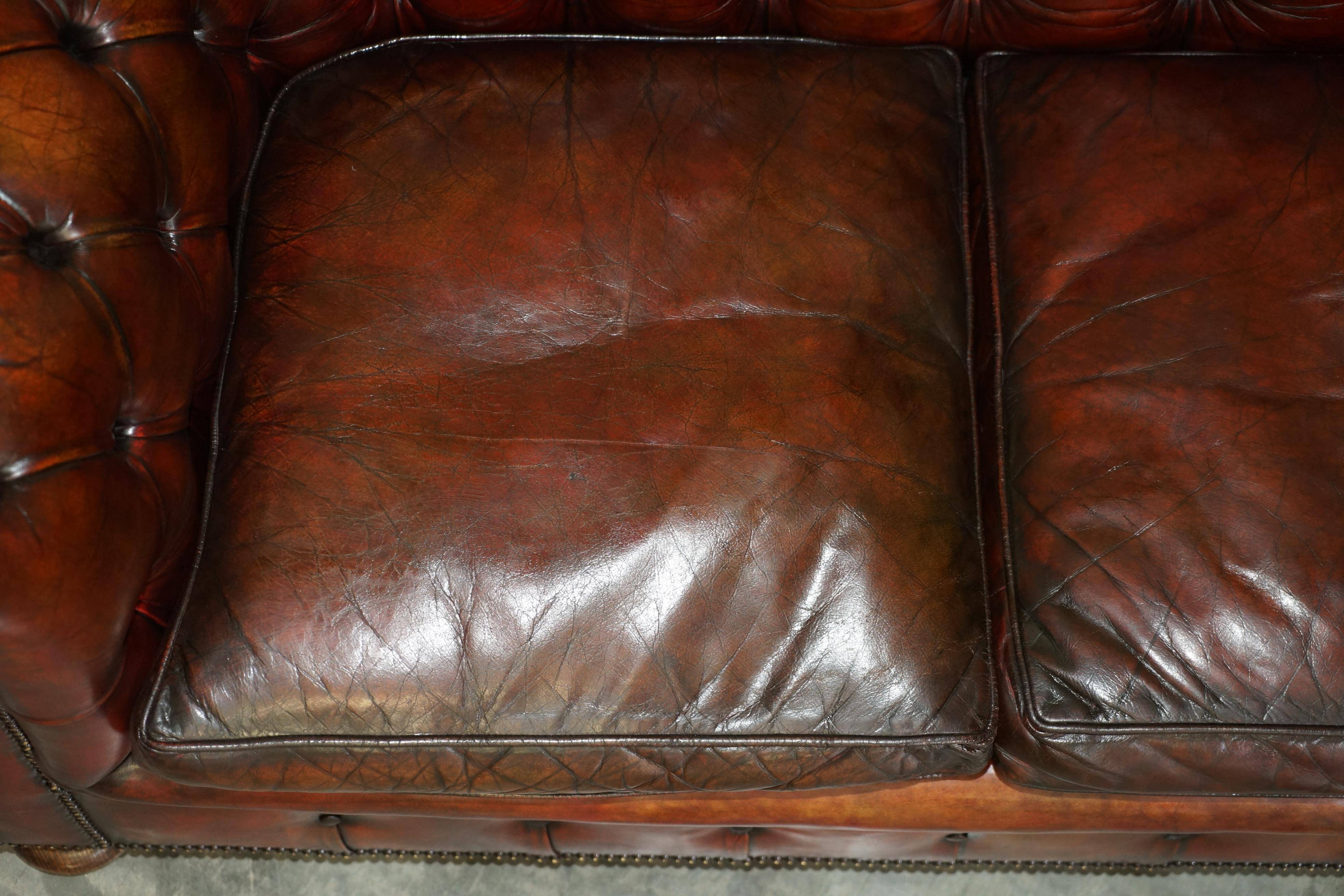 Pair of restored antique Chesterfield sofas in Boudreaux leather.