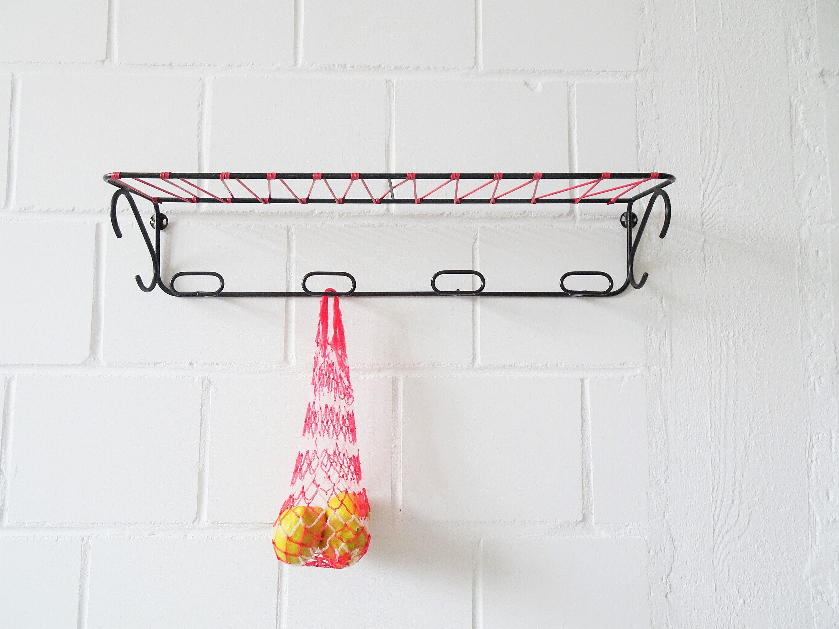 Minimalist wall coat rack in string design in black and red