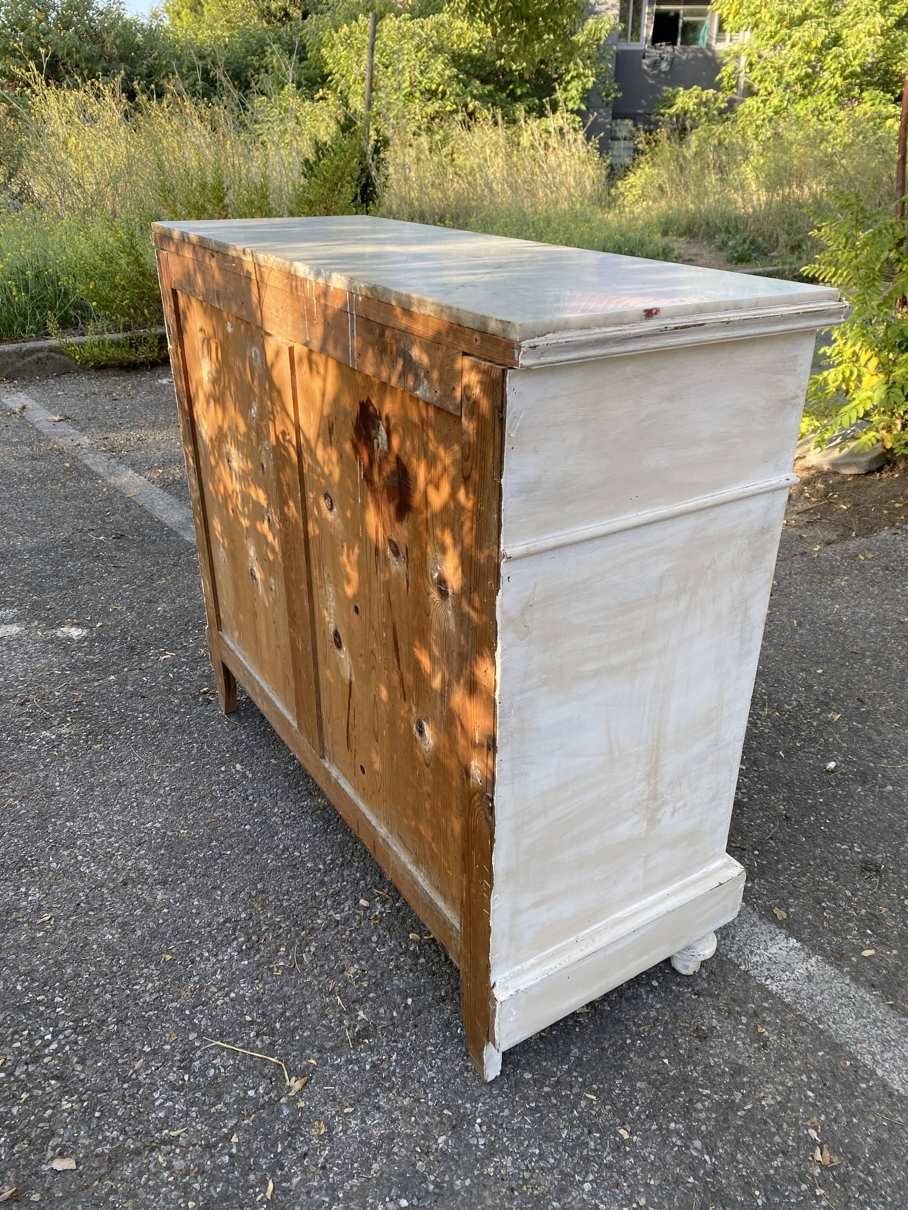 Old chest of drawers in bleached wood with white marble top