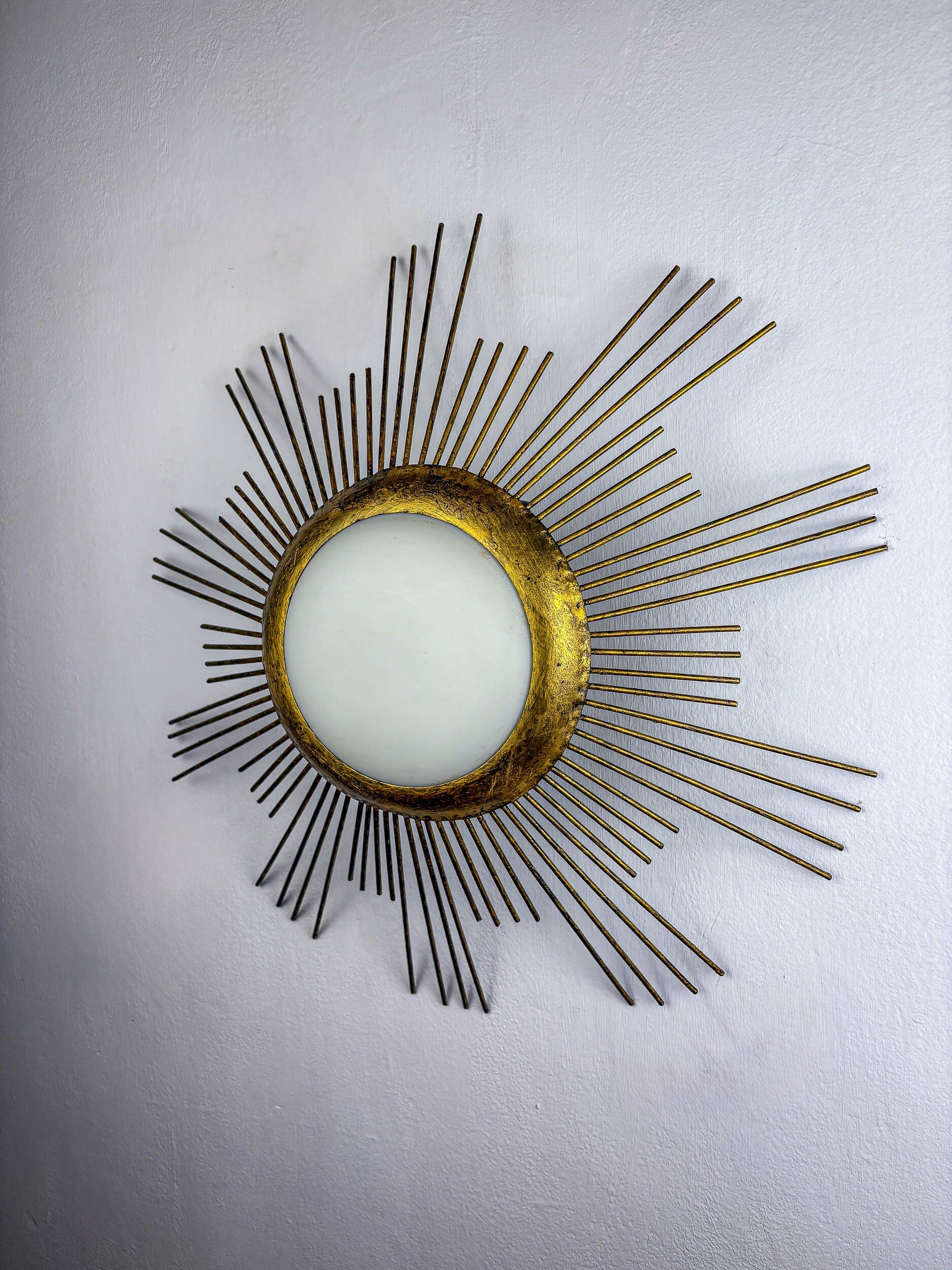 Large sunburst brutalist ceiling flush mount or pendant – gilt iron rays & opaline, France, 1950s