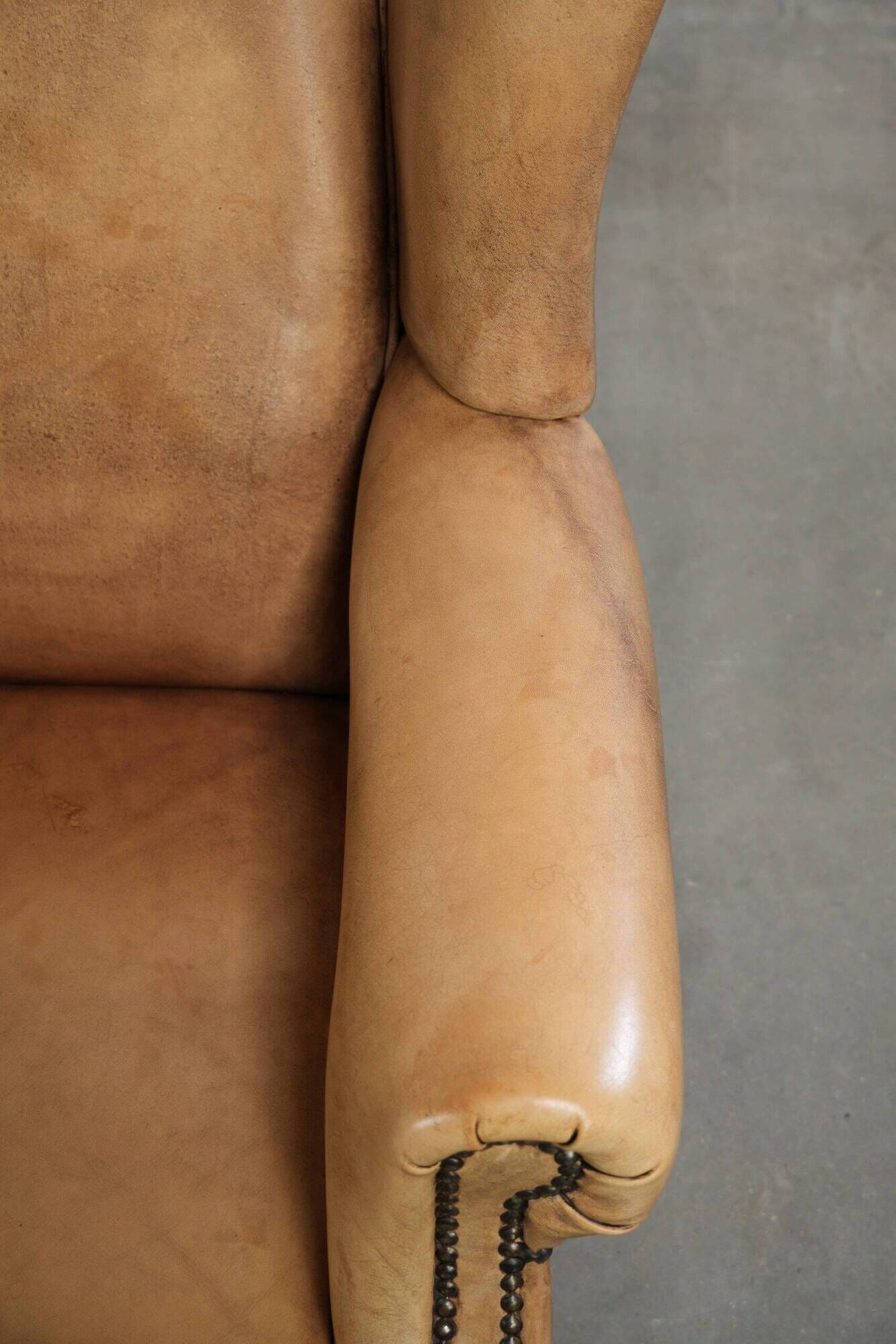 Set of two light cowhide wingback armchairs with a timeless English look