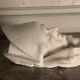 Marble sculpture, man's head in a hat.