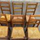6 light solid wood chairs with high straw backs, farmhouse style.