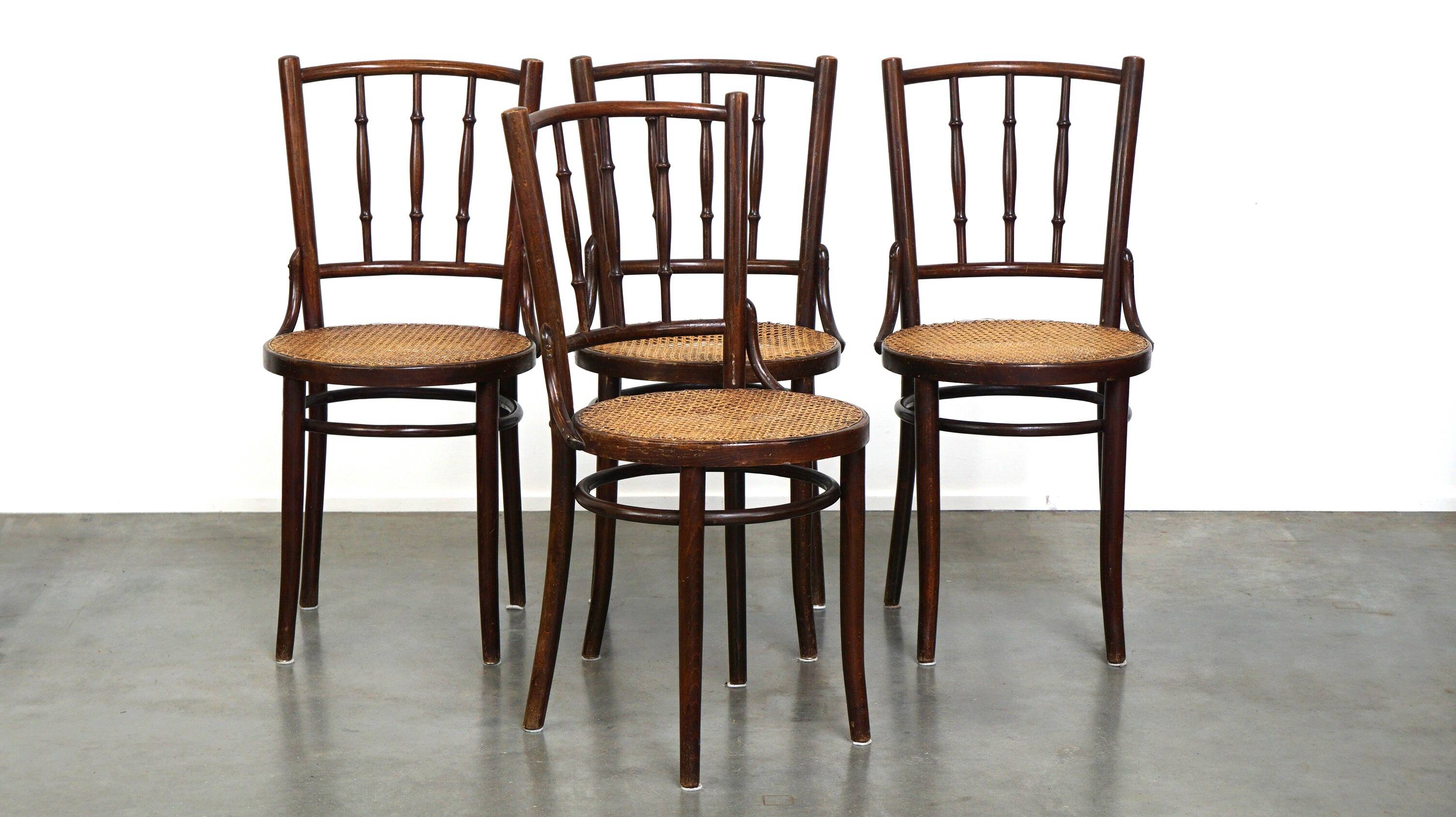 4 antique wooden and cane bistro chairs