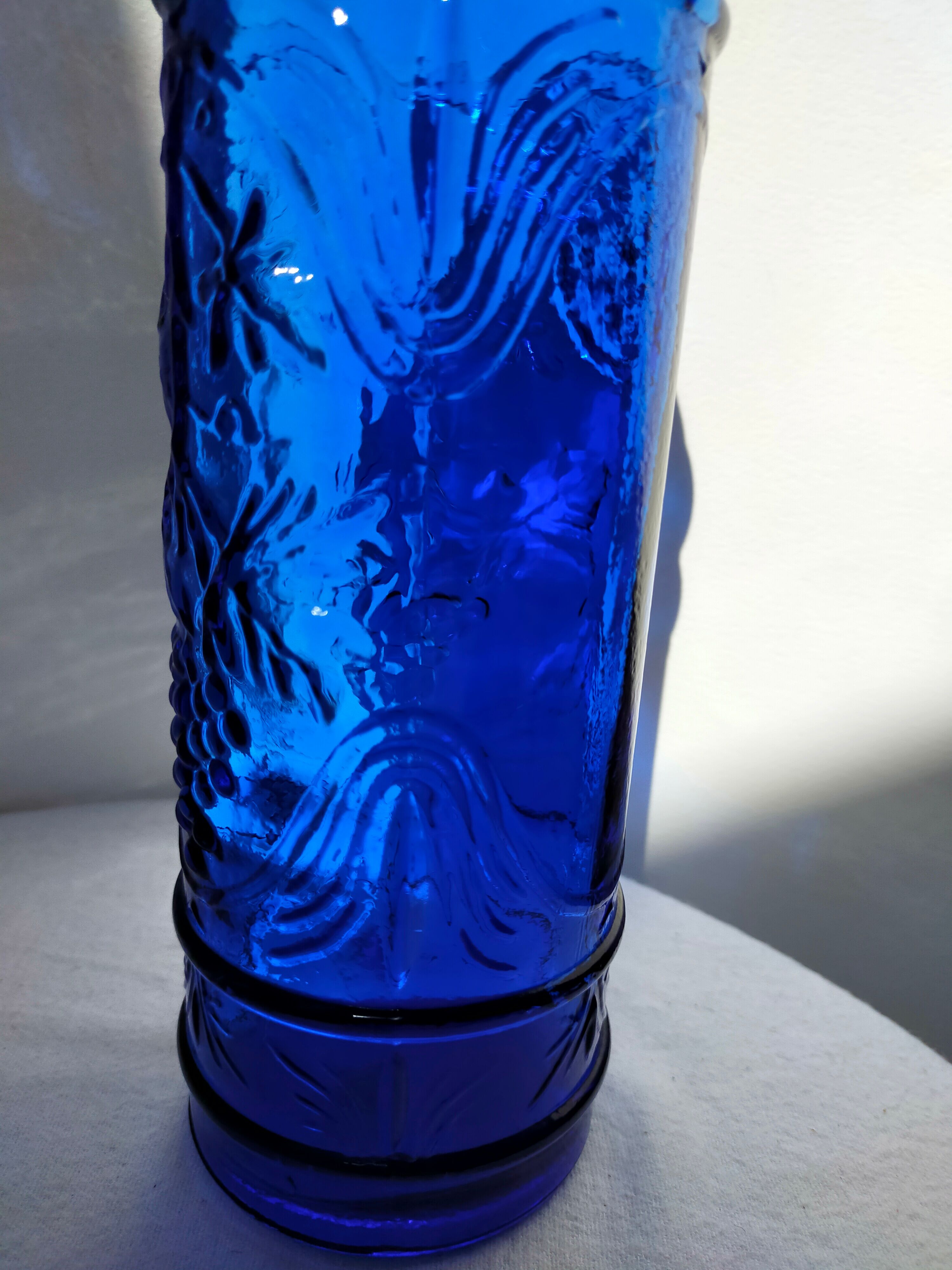 cobalt blue molded glass bottle in relief decoration bunches of grapes