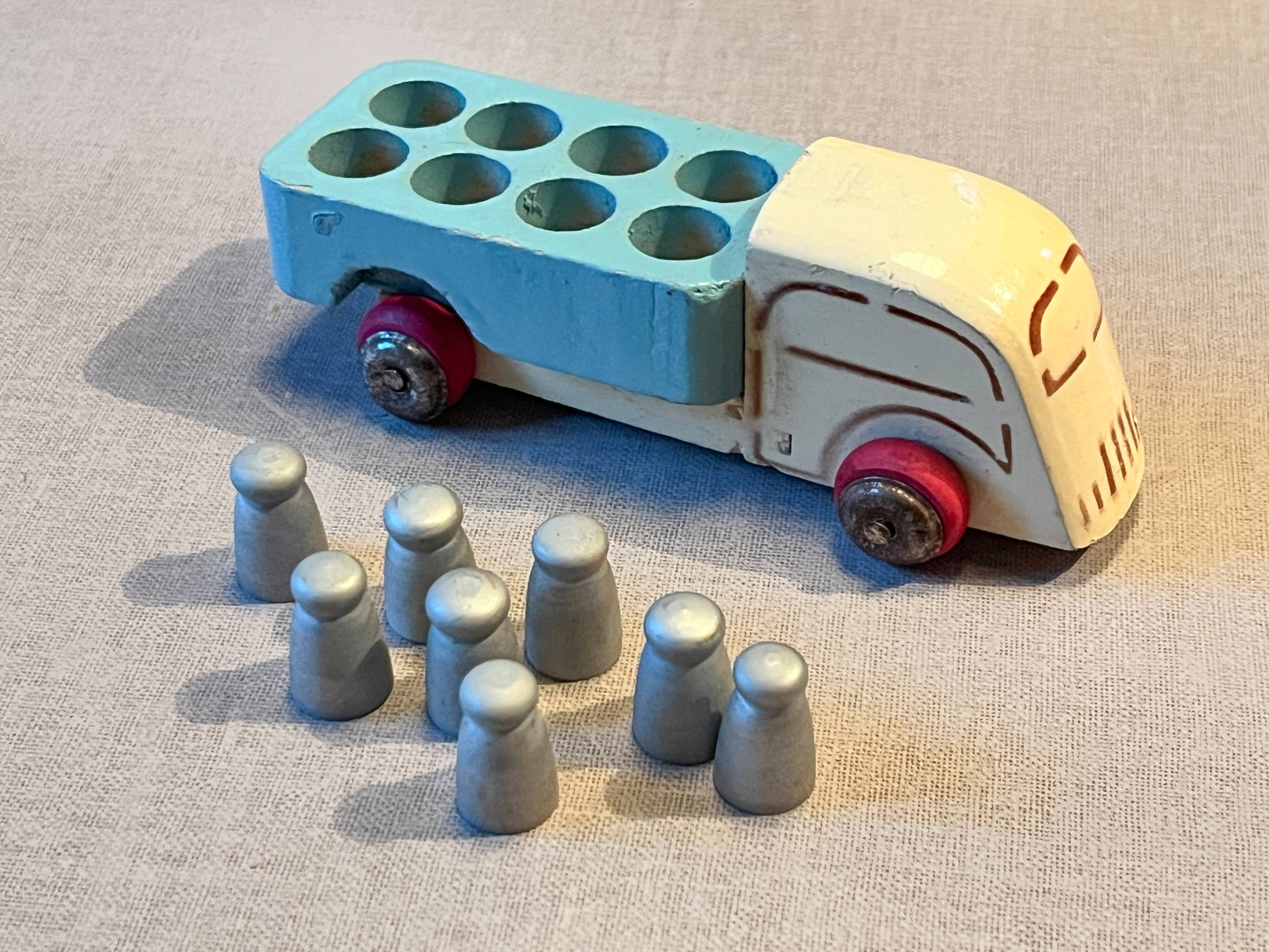 Small wooden milk truck with its cans, antique toy