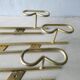 Set of 3 coat hangers in gold metal, 60s