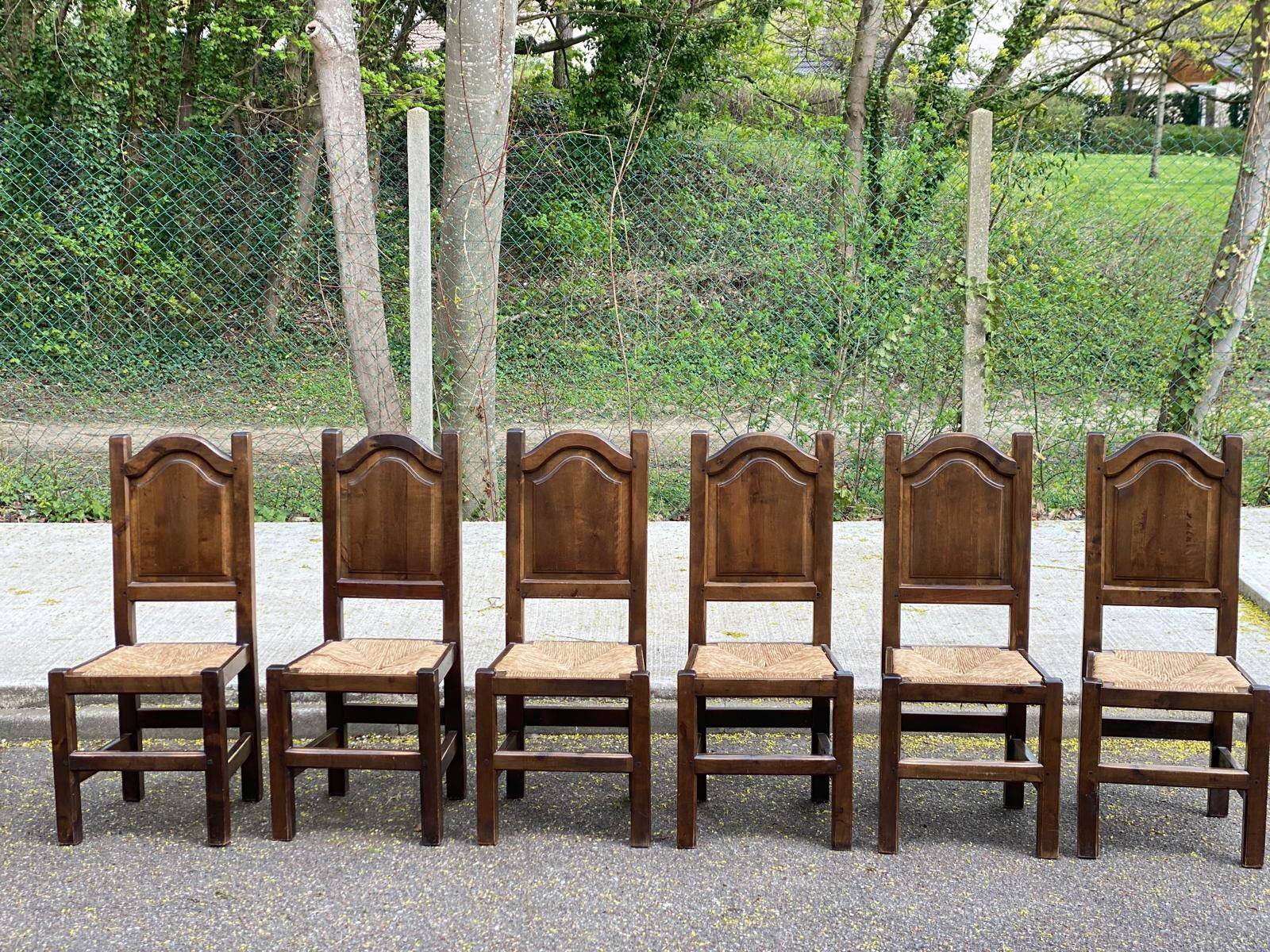 6 dining chairs in a country or farmhouse style, made of dark solid wood and rush-seated.