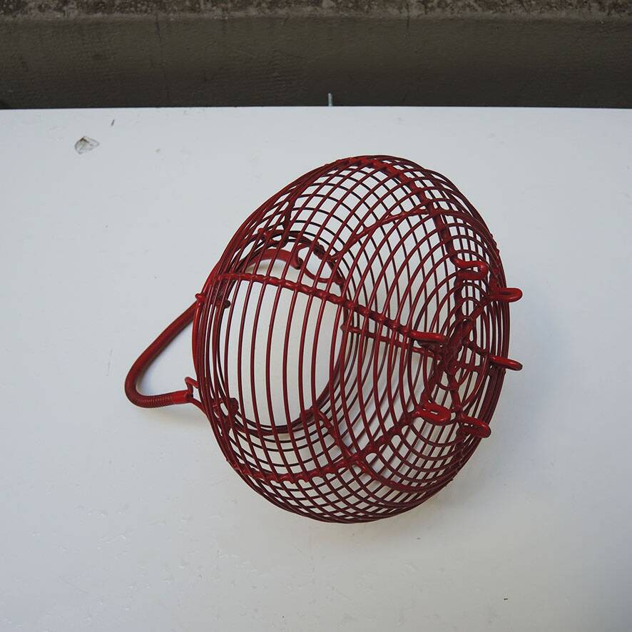 Old red-painted metal egg basket