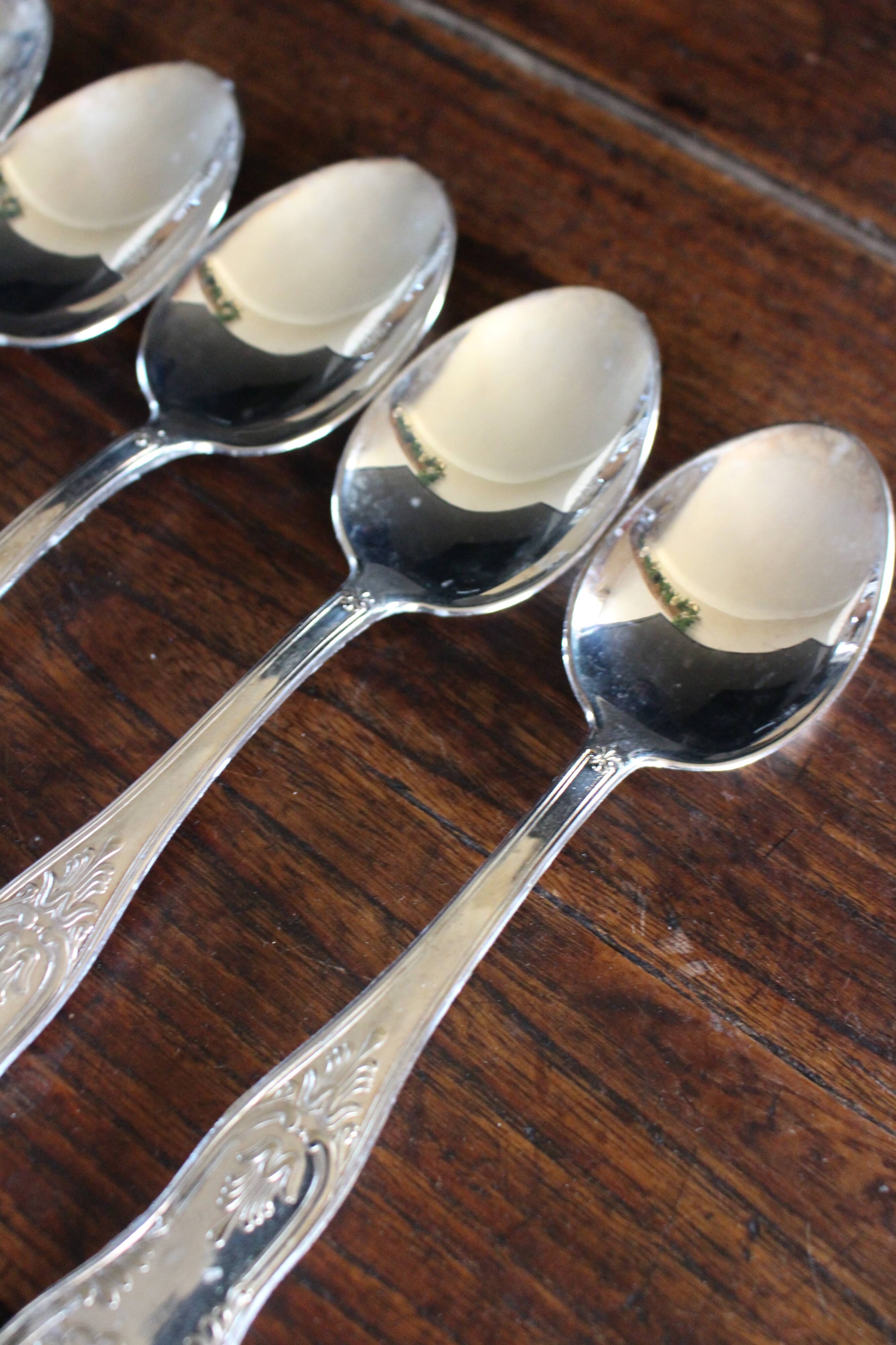 A set of 7 large metal shell spoons
