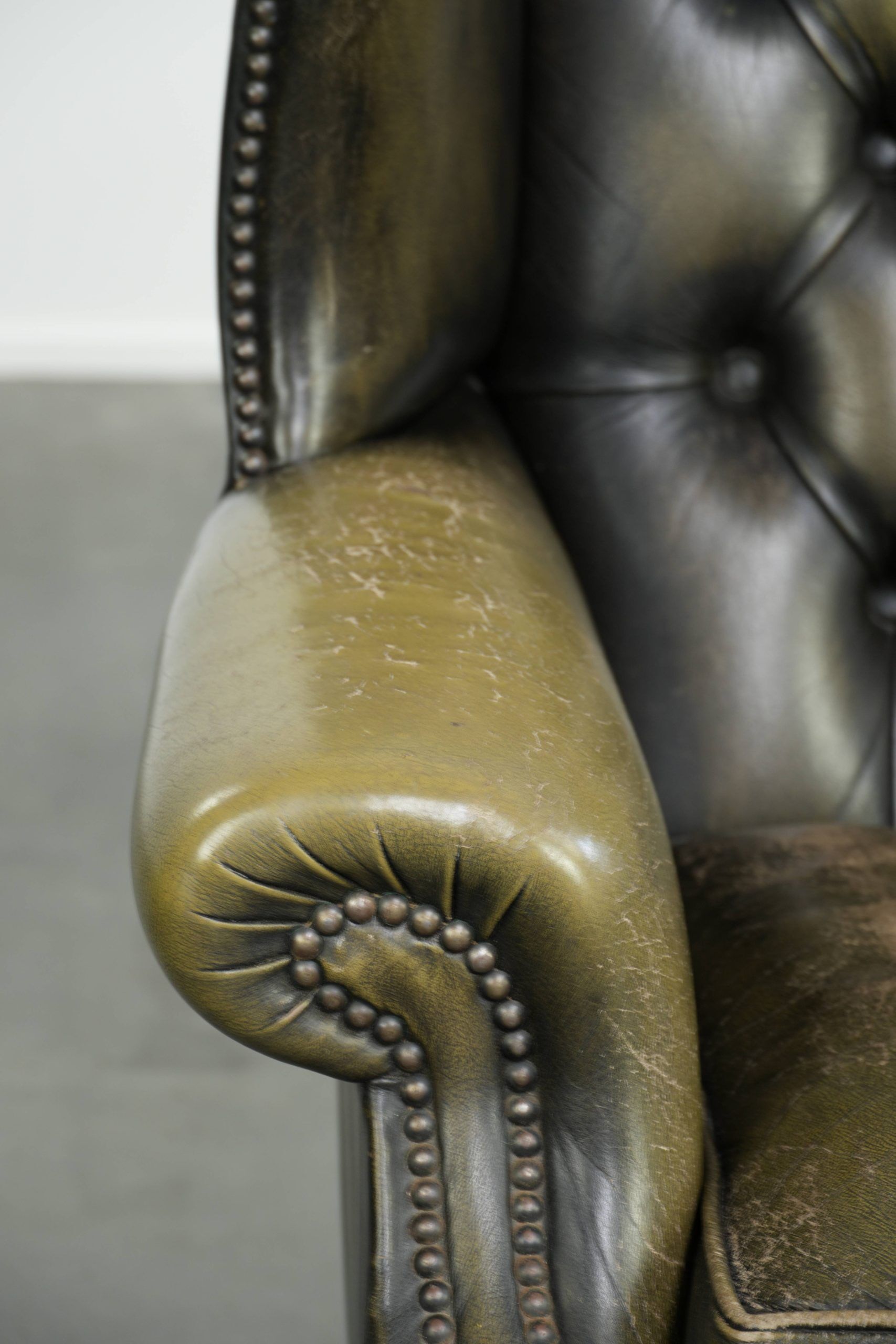 Vintage cowhide leather Chesterfield wingback armchair in a green colour