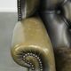 Vintage cowhide leather Chesterfield wingback armchair in a green colour