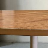 Mid-century round tulip dining table with a wooden top, vintage 1970s design.