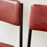 Pair of vintage stacking chairs with red vinyl upholstery