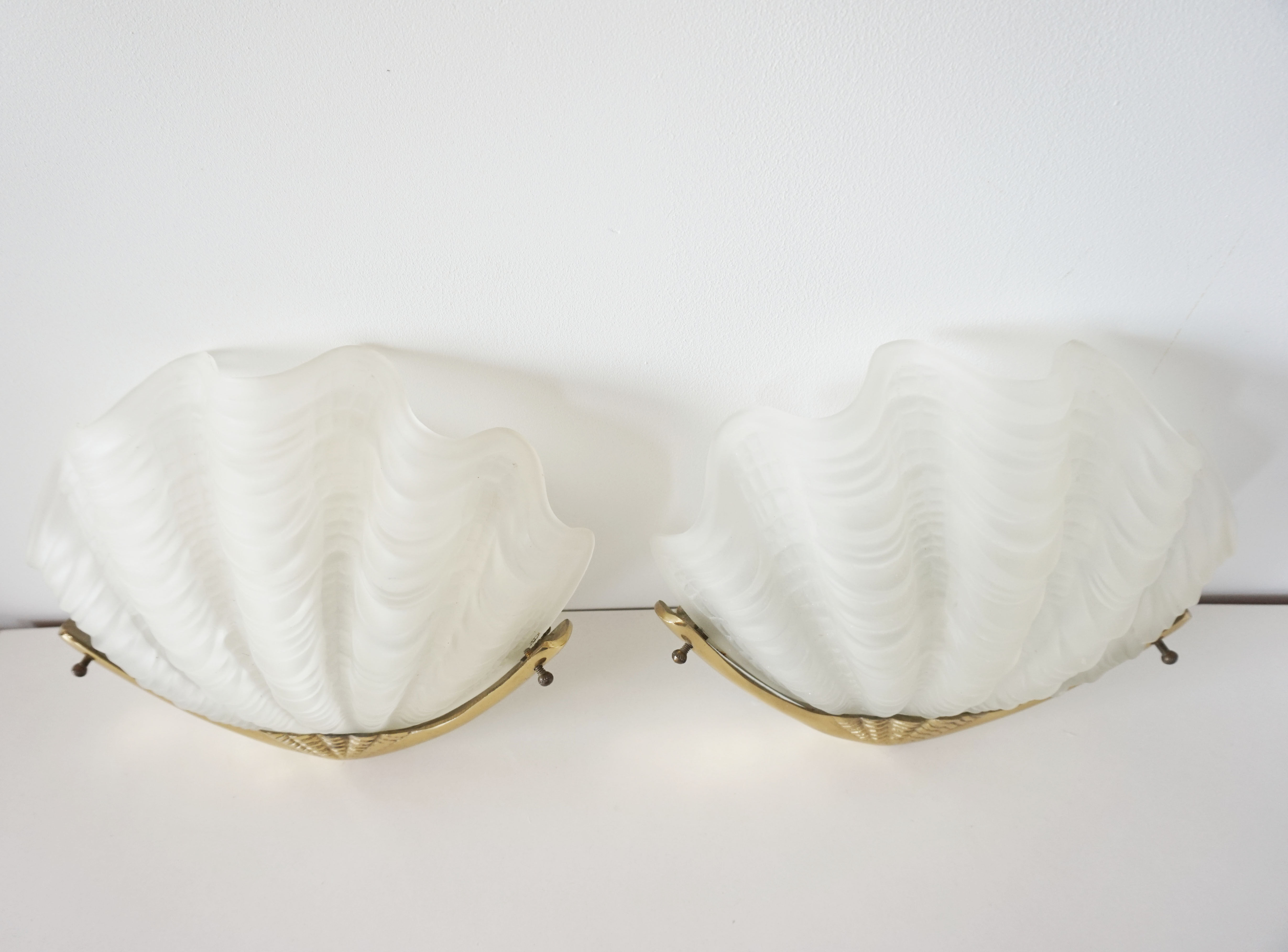 Pair of glass and gold metal shell sconces