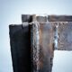 2 brutalist steel side tables with primitive  scene motifs etched glass