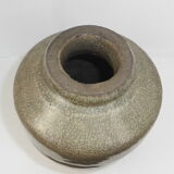 Ancient vase in khaki grey-green cracked sandstone