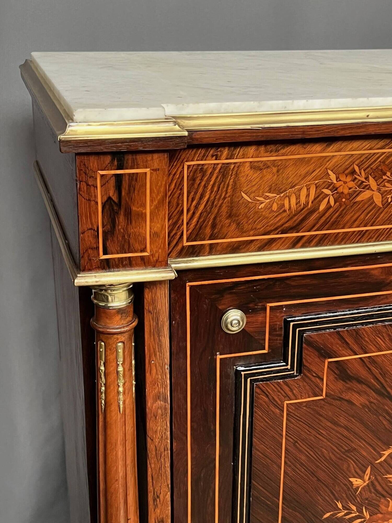 Elegant Napoleon III style commode with fine marquetry, gilded bronze mounts, and a marble top.
