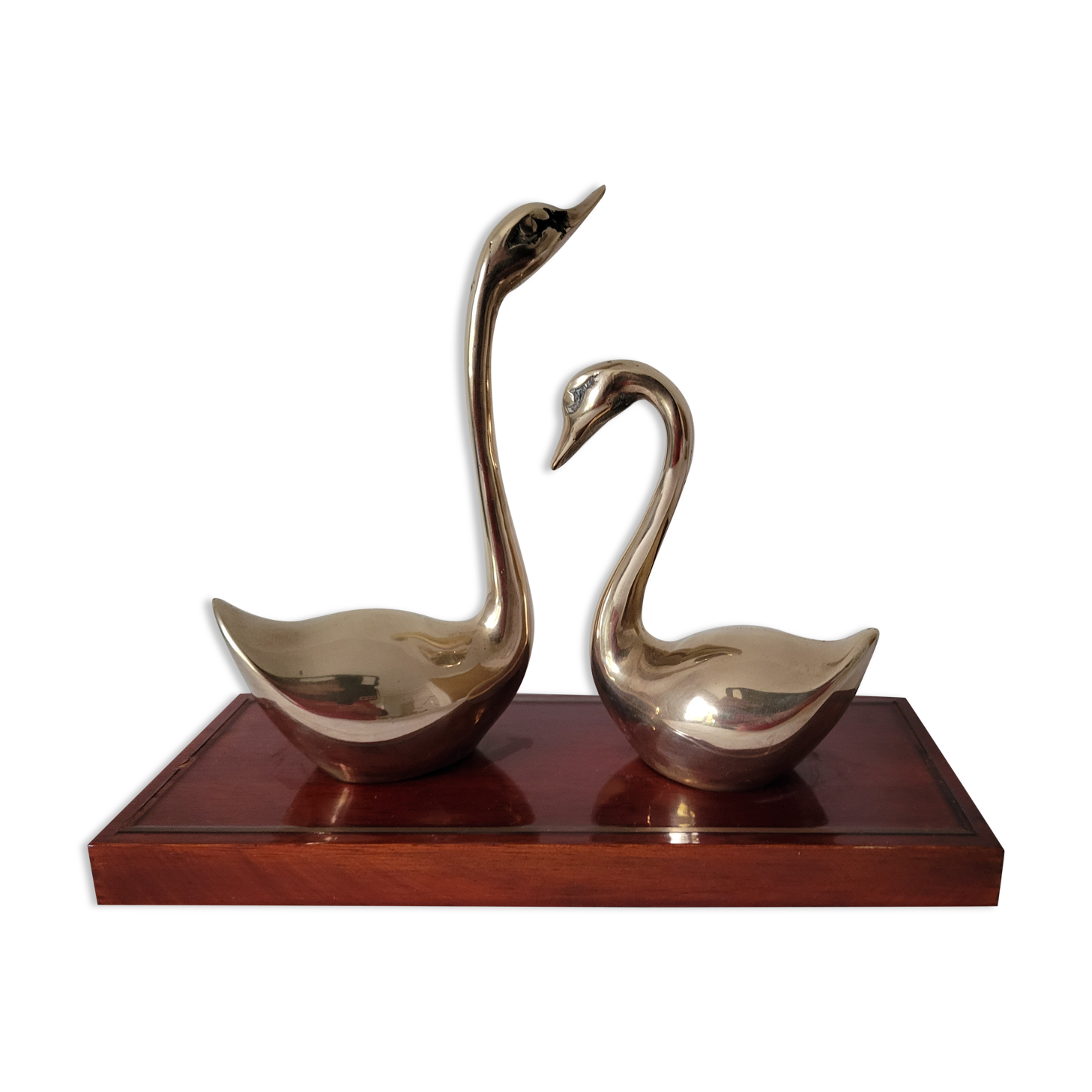 Duo of brass swans on base