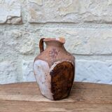 Old small pitcher in glazed terracotta