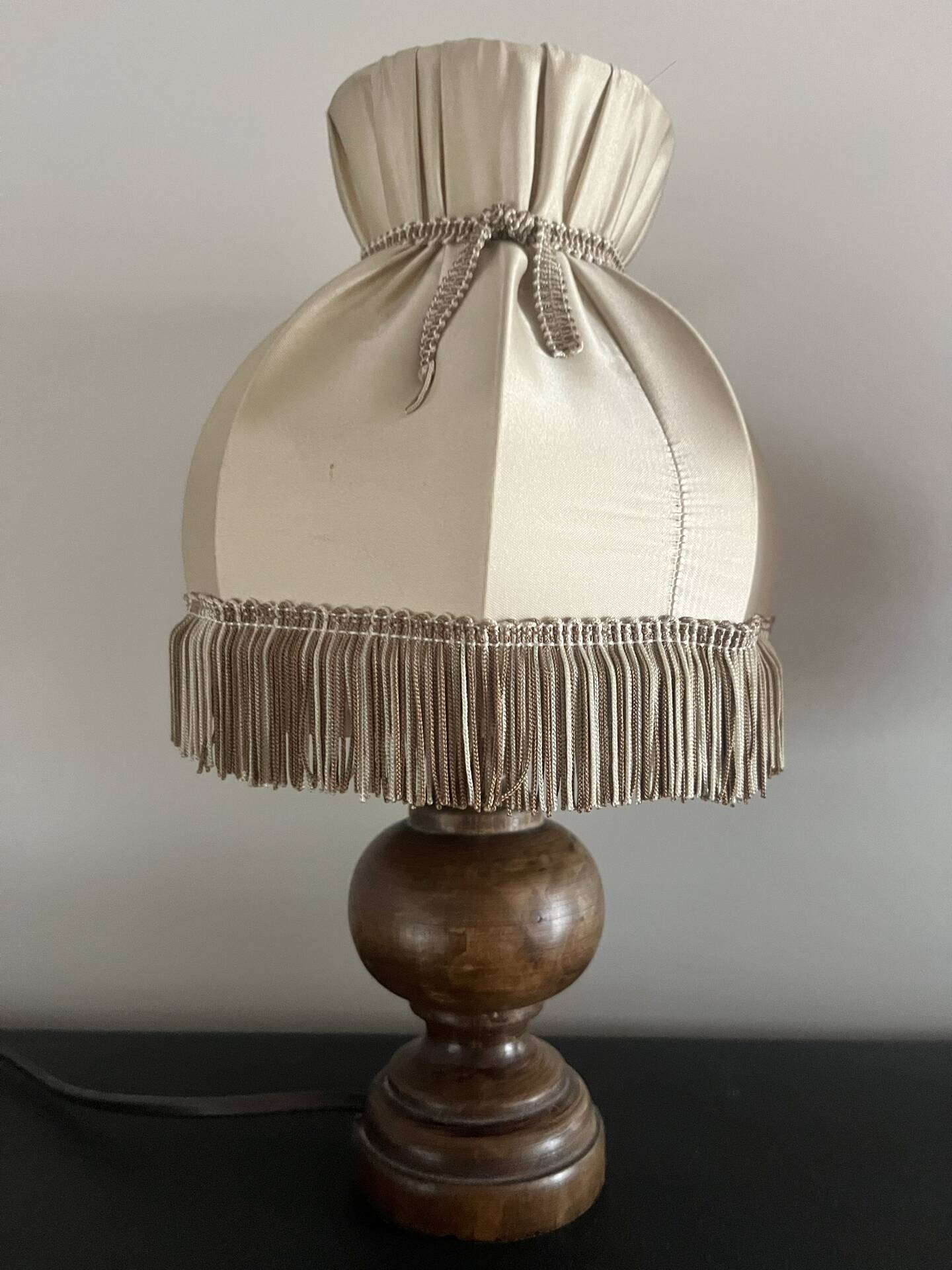 Pair of wooden bedside lamps with vintage fringe lampshades.
