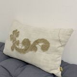Cushion in vintage fabric with ornamentation
