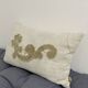 Cushion in vintage fabric with ornamentation.