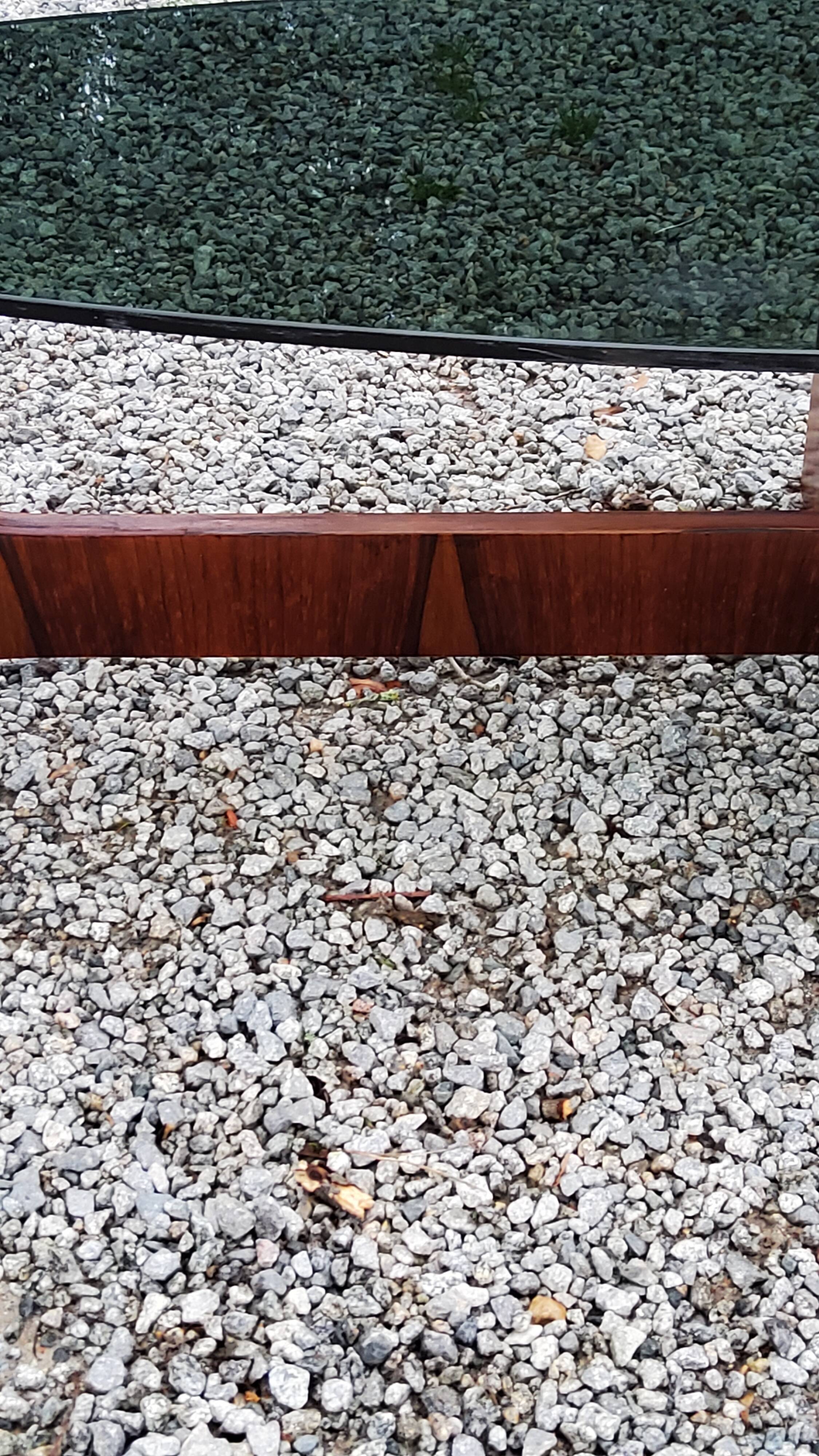 Designer coffee table by Hugues Poignant in rosewood and smoked glass from the 70s