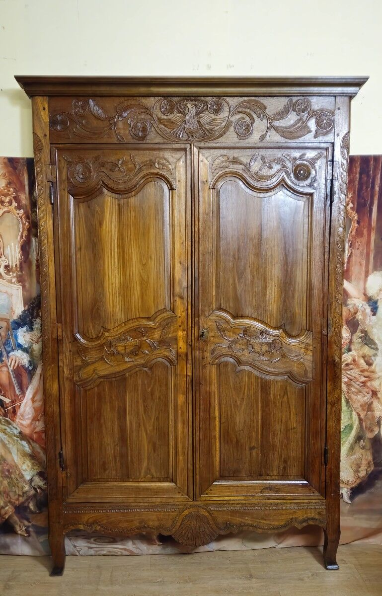 Louis XV period wardrobe façade, solid wood architectural elements, richly carved.