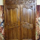 Louis XV period wardrobe façade, solid wood architectural elements, richly carved.