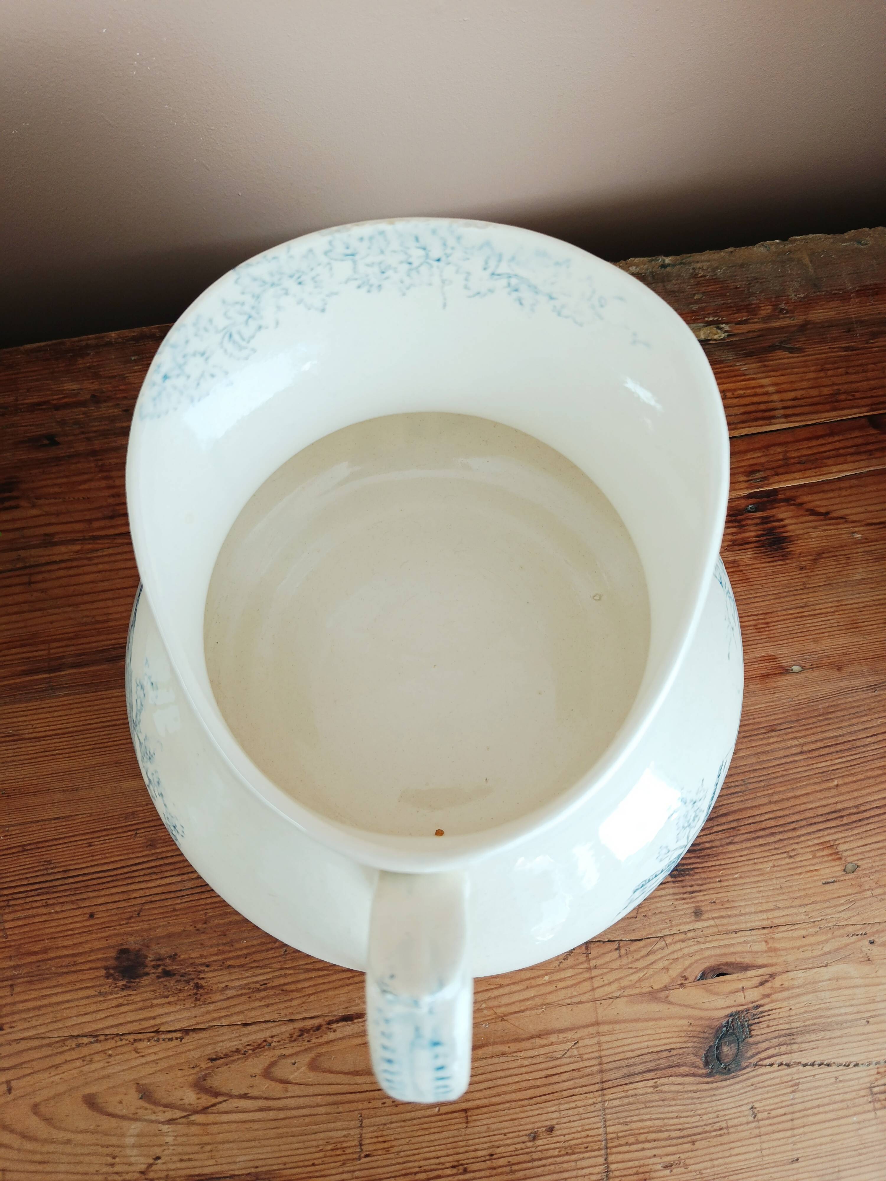 Old bulbous jug in ironstone earthenware